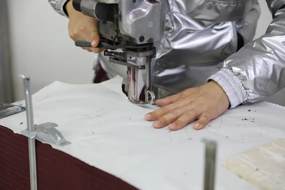 Close-up of fabric cutting with an industrial cutting machine