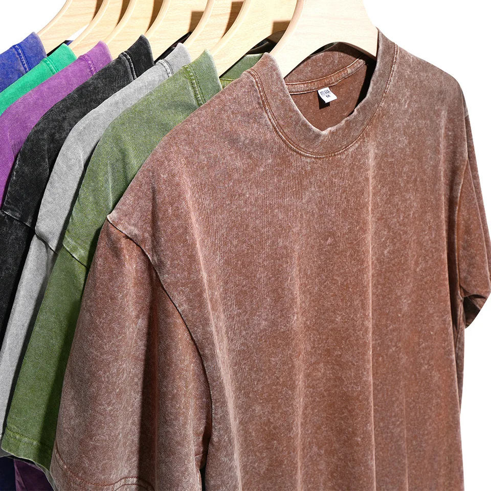 Washed oversized T-shirts in assorted colors on wooden hangers — user-provided reference