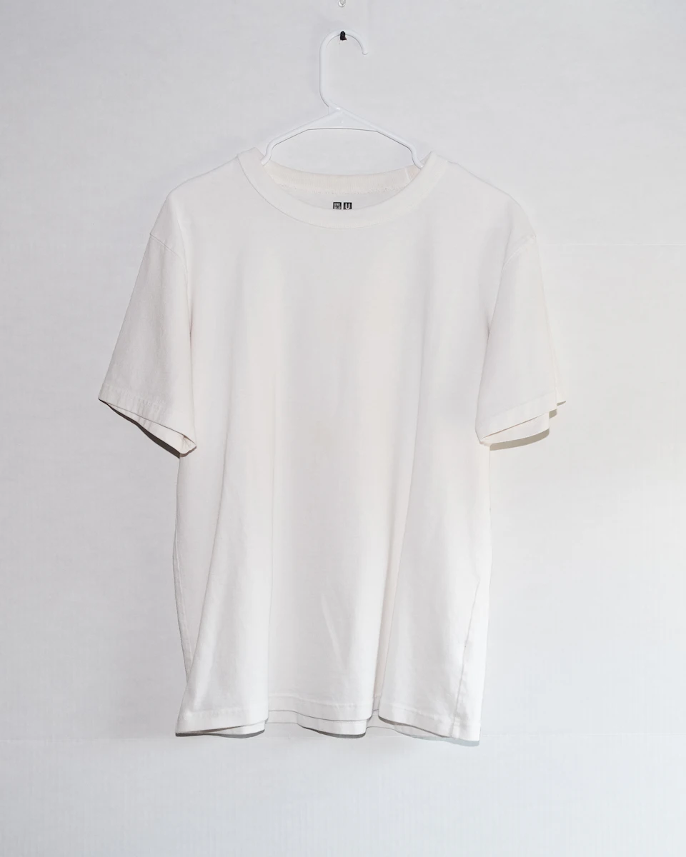 White T-shirt displayed on a hanger — stock reference photograph